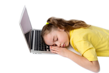 The little girl in the yellow T-shirt got tired and fell asleep at the laptop. The concept of distance learning during COVID-19.