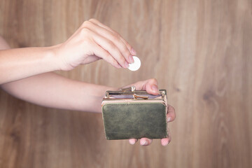 woman holding coins and wallet