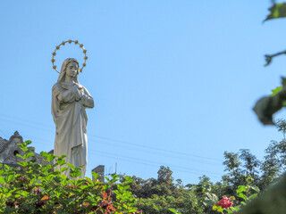 Monument to the Mother of God with a golden halo over the naked