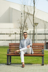 Obraz premium Businessman is psoing on the bench