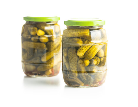 Small pickles. Marinated pickled cucumbers in jar.