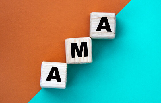 AMA - acronym on wooden cubes on a multi-colored background