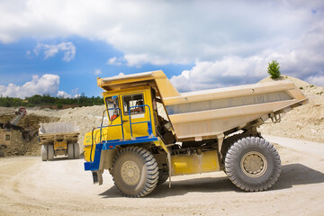 A large quarry dump truck loaded with rock.