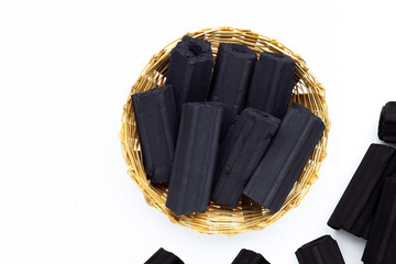 Non smoke wood charcoal in bamboo basket on white background.