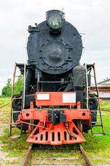 front view of a large black retro steam locomotive