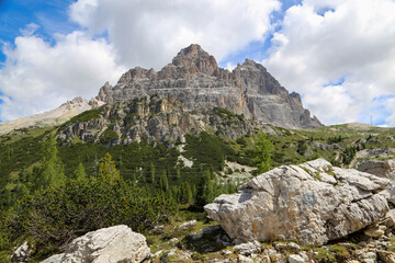 Tre  Cime di Lavaredo under blue sky with clouds