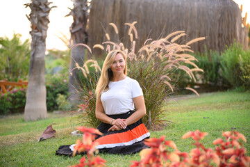 Portrait of Mature Woman on a Background of City Park, Aged Forty Years.