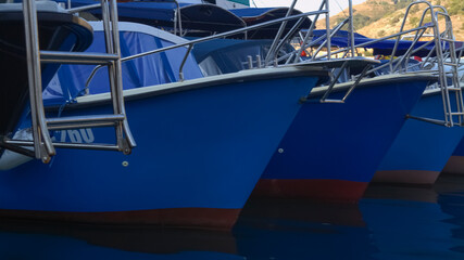 three blue boats stand in the harbor at the pier. Balaklava Bay. Sevastopol. Crimea