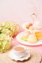 a white cup of coffee with a vase of sweets and a bouquet of flowers in soft, pastel colors. Congratulations on your birthday or mother's day.