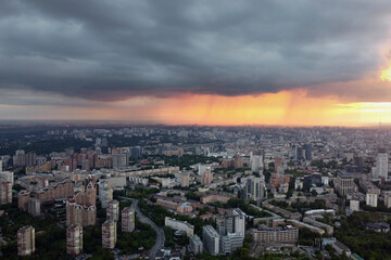 Naklejka na ściany i meble Rain in the city Kyiv, drone photo. The photo shows the houses of the metropolis