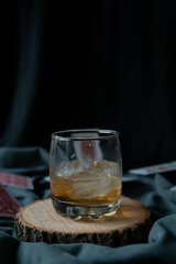 whiskey glass in an elegant setting with poker cards in the background