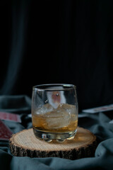 whiskey glass in an elegant setting with poker cards in the background
