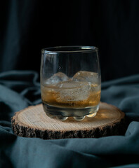 whiskey glass in an elegant setting with poker cards in the background