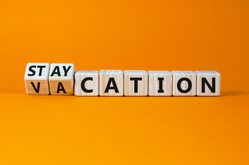Vacation or staycation symbol. Turned wooden cubes and changed the word vacation to staycation....