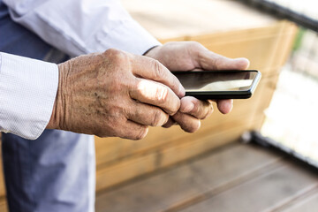 Senior man and his smartphone. Modern mature man have fun using smart phone outdoors
