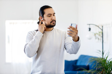 Person on the phone with iphone in white department.