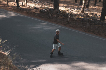 a young gay man skating on in-line skates.