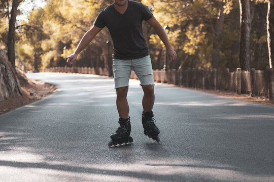 a young gay man skating on in-line skates.