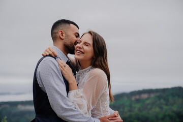 Obraz premium attractive man and woman cuddling and laugh in nature. romance in relationship