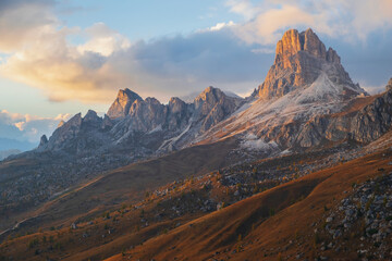 Famous Passo di Giau, Monte Gusela at behind Nuvolau gruppe the Dolomites mountains, near the famous Cortina d’Ampezzo city at sunset in South Tyrol