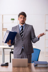 Young male employee working in the office