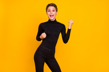 Portrait of attractive cheerful girl having fun rejoicing great offer deal isolated over bright yellow color background