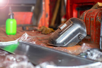 concept of work as a welder, a welder's mask at a factory.