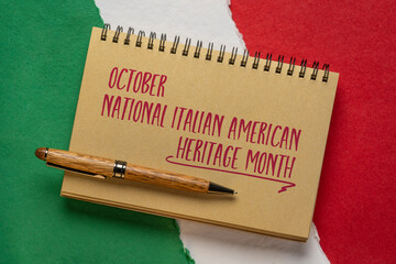 October - National Italian American Heritage Month, handwriting in a spiral notebook against paper abstract in colors of national flag of Italy (green, white and red), reminder of cultural event