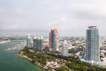 Fototapeta na wymiar Beautiful aerial view overlooking South Pointe Park and high-rise condominiums on Miami Beach with Government Cut and Meloy Channel Marina below.