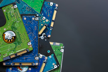 Pile of 2.5 inch hard disk drives from the computer, hdd on dark background, top view, space for text. Part of computer pc, laptop - 458135091