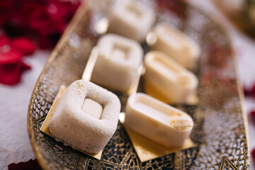Candy bar on a vintage wedding plate with lots of chocolates. The interior is decorated in brown colors