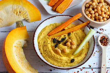Homemade hummus from chickpeas and pumpkin with vegetables. Autumn Pumpkin Snacks. Vegetarian cooking