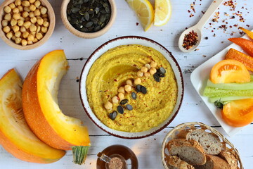 Homemade hummus from chickpeas and pumpkin with vegetables. Autumn Pumpkin Snacks. Vegetarian cooking