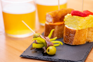TYPICAL SPANISH APPETIZERS AND TWO GLASSES OF BEER.