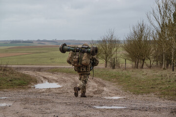 British army soldier completing an 8 mile tabbing exercise with fully loaded 25Kg bergen