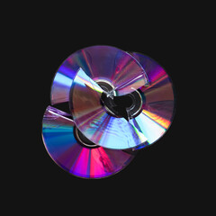 Two broken CD and DVD discs isolated on black background. Damaged CD, DVD compact discs. Data...