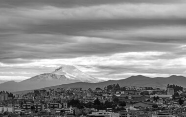 Quito city with snowcapped Cayambe volcano in black and white, Ecuador.
