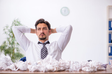 Young male employee in brainstorming concept