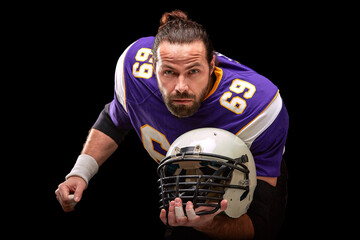 Portrait of american football player with helmet in hand close up