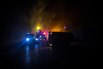 Police car chasing a car at night with fog background. 911 Emergency response police car speeding to scene of crime.