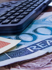 Selective focus of mixed brazilian real money notes and pen