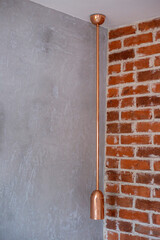 Bronze long modern lamp on gray wall background