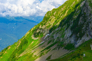 Obraz premium Mountain peaks in summer on a sunny day together with clouds