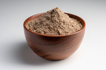 Raw flax seeds flour in a wooden bowl with on white background.