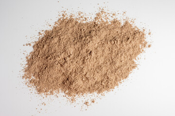 Raw flax seeds flour on white background.