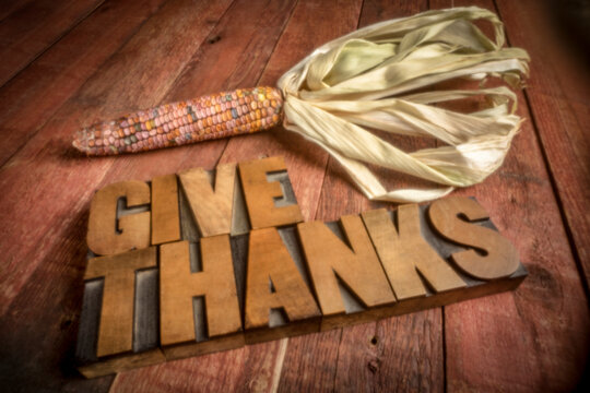 give thanks in vintage letterpress wood type with a decorative corn, soft focus image shot with a lensless pinhole camera, Thanksgiving theme