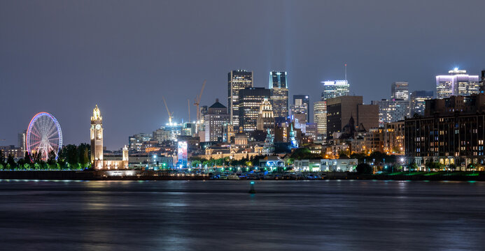 View of downtown Montreal city skyline and Saint Lawrence River at night, Quebec, Canada.