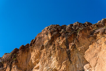 Fototapeta na wymiar Mountain. a mountain with brown and dark brown tones. The harmony of blue sky and unique rocks