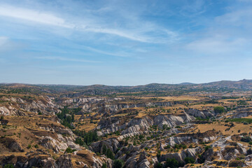 Cappadoci, a landscape photo taken from Uchisar castle, houses of the same structure and scattered but impressive architecture of the city, light blue sky and amazing landscape, travel to Turkey