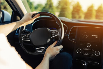 Man driving a car, an image of a man driving a car holding a steering wheel